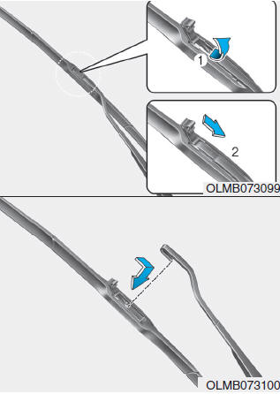 Hyundai Tucson: Wiper blades. 2. Lift up the wiper blade clip (1). Then pull down the blade assembly (2) and