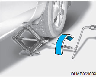 Hyundai Tucson: If you have a flat tire. 8.Insert the jack handle into the jack and turn it clockwise, raising the vehicle